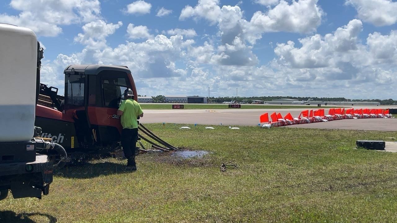 A DUGS operator at the controls of the JT32 drill rig on an airfield job